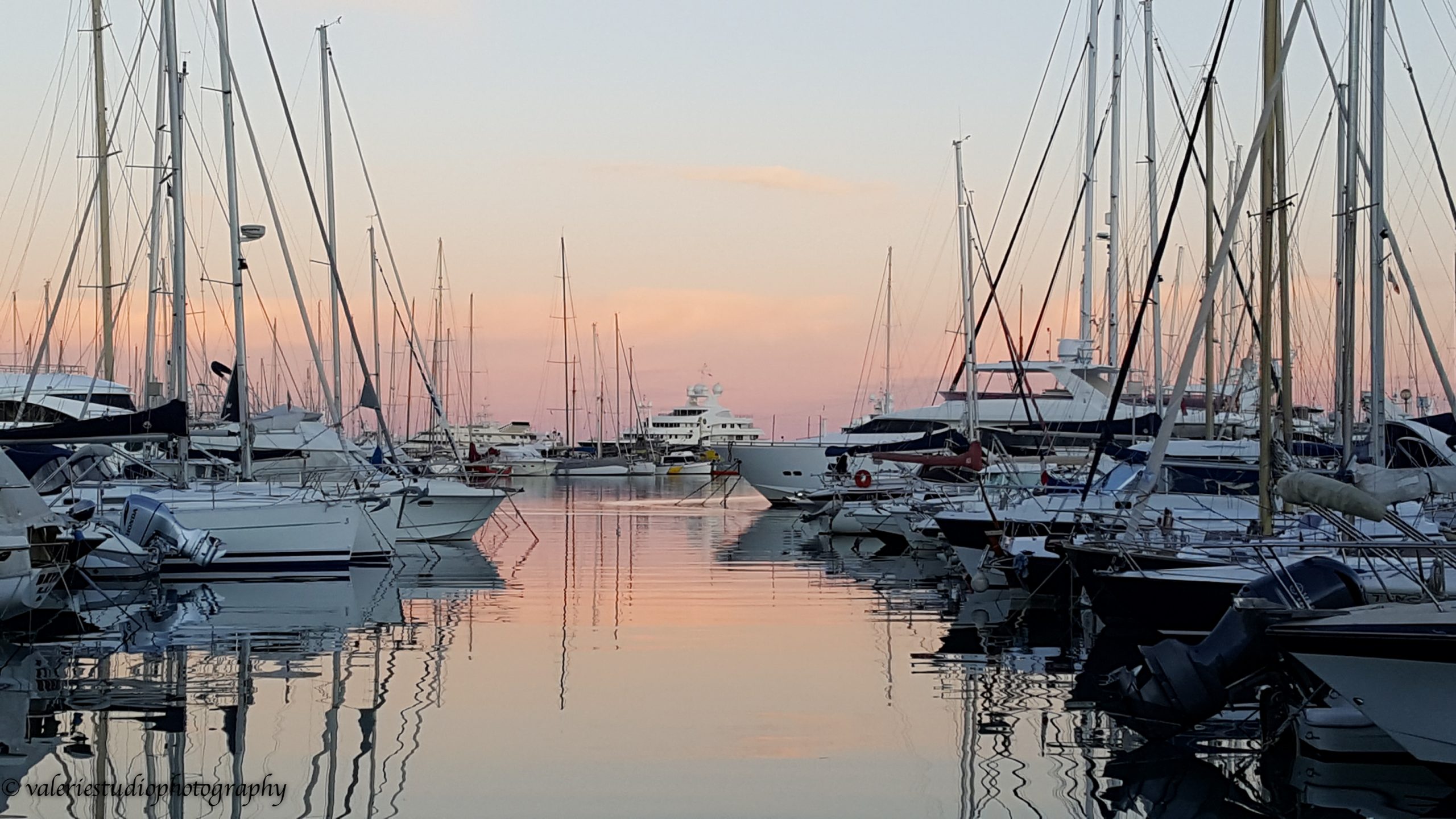 Med season blog article superyachts in a marina at sunset